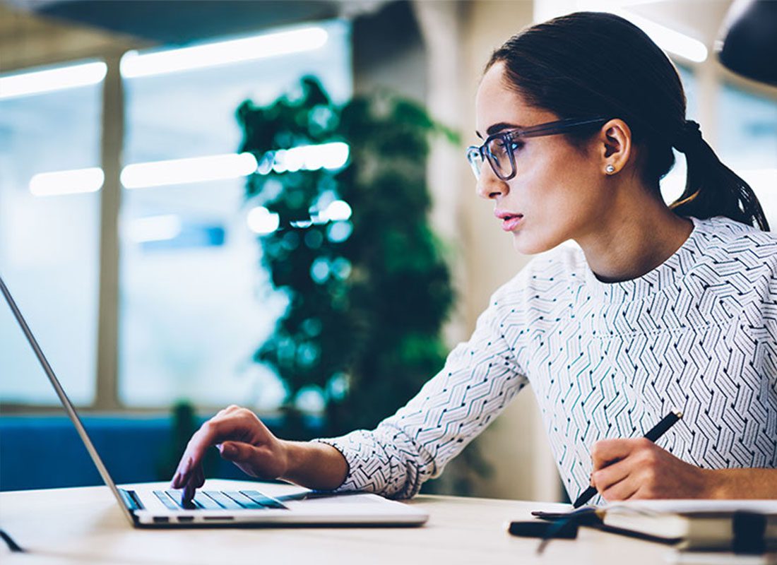 Resources - Business Woman Using a Computer to Get Insurance Resources