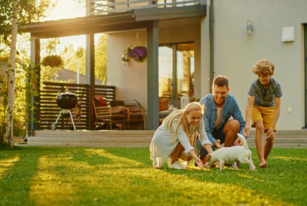 Custom-Landing-Page-Family-Outside-of-Their-Home-Grilling-and-Playing-with-the-Dog